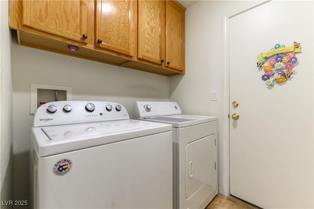 laundry room with cabinets and washer and clothes dryer