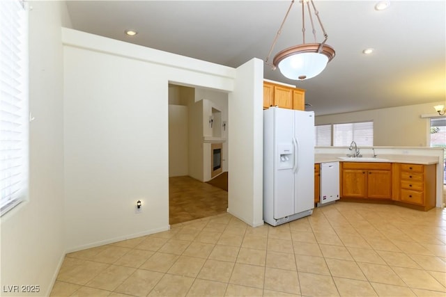 kitchen with sink, light tile patterned floors, pendant lighting, and white appliances