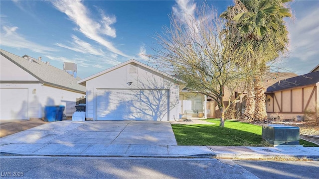 view of front of property featuring a garage and a front lawn