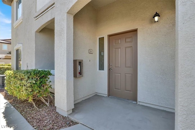 property entrance featuring a patio area and central air condition unit