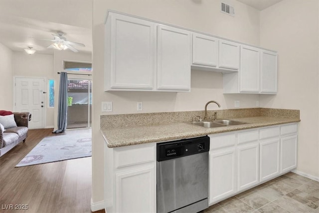 kitchen featuring ceiling fan, white cabinets, stainless steel dishwasher, light hardwood / wood-style flooring, and sink