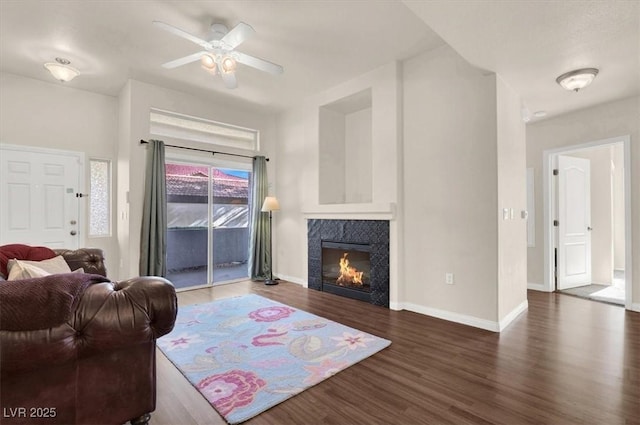 living room with ceiling fan and dark hardwood / wood-style floors