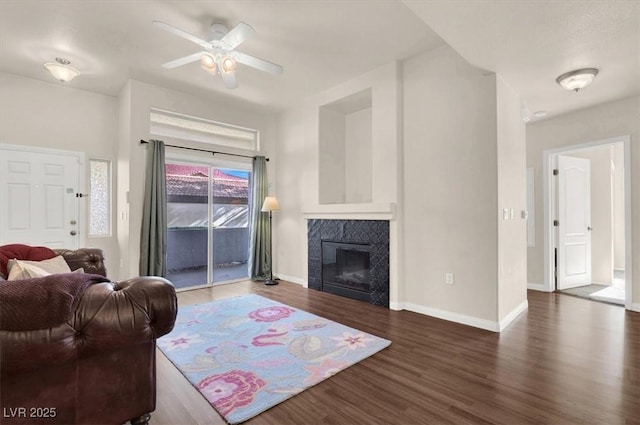 living room with ceiling fan and dark hardwood / wood-style flooring