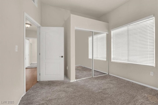 unfurnished bedroom featuring carpet floors and a closet