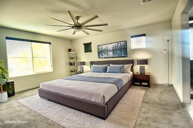 bedroom with ceiling fan and light carpet