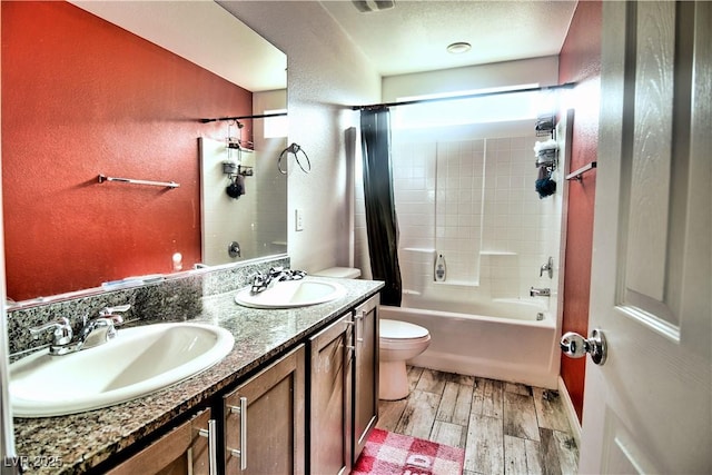 full bathroom featuring toilet, vanity, and shower / bath combo with shower curtain