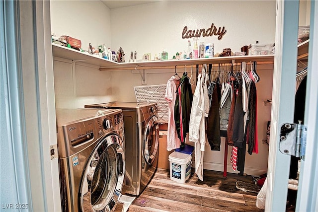 clothes washing area featuring washing machine and dryer and wood-type flooring