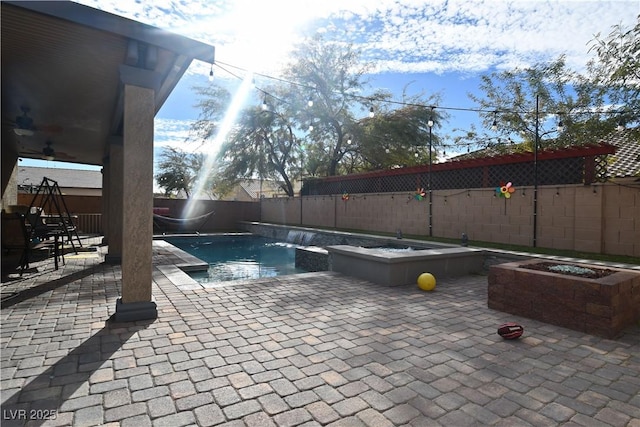 view of swimming pool featuring pool water feature, a jacuzzi, and a patio area