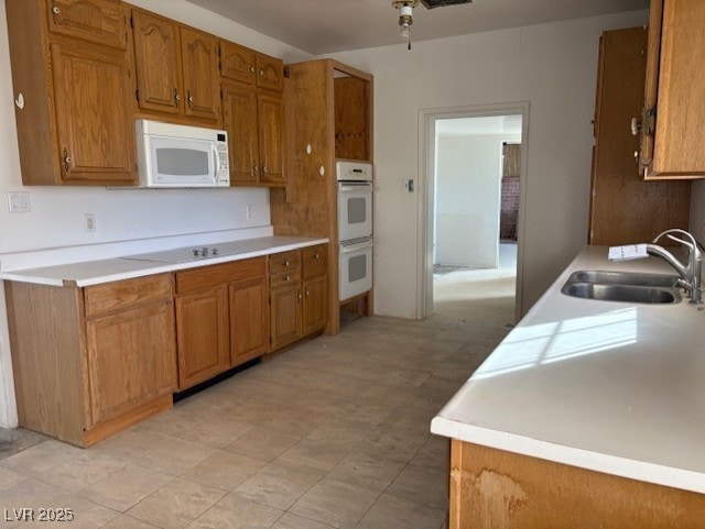 kitchen with ceiling fan, sink, and white appliances