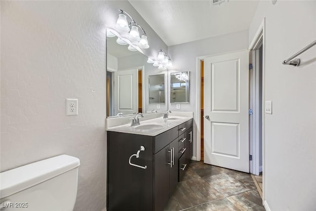 bathroom with toilet and vanity