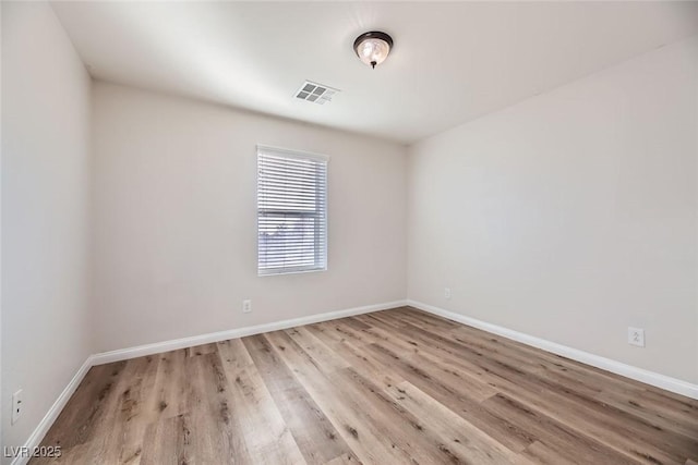 spare room with light wood-type flooring