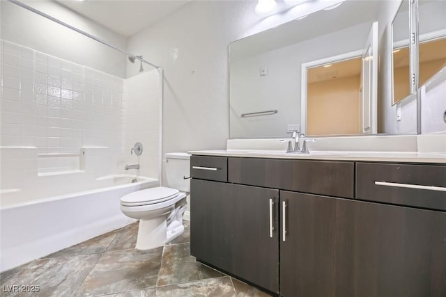 full bathroom featuring washtub / shower combination, vanity, and toilet