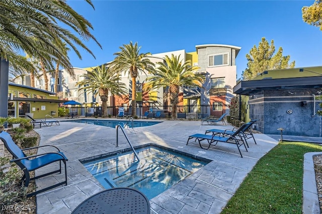 view of pool with a hot tub and a patio