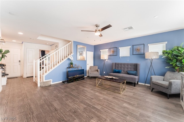 living room featuring hardwood / wood-style flooring and ceiling fan