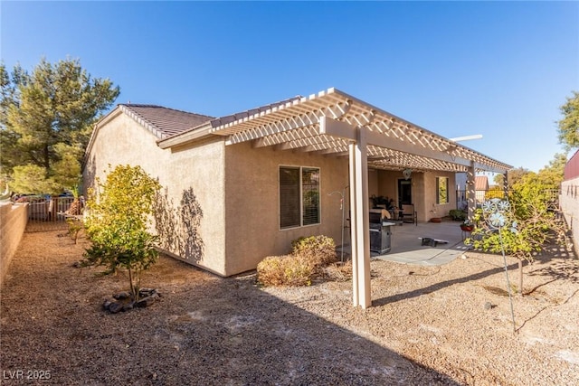 back of property featuring a pergola and a patio area