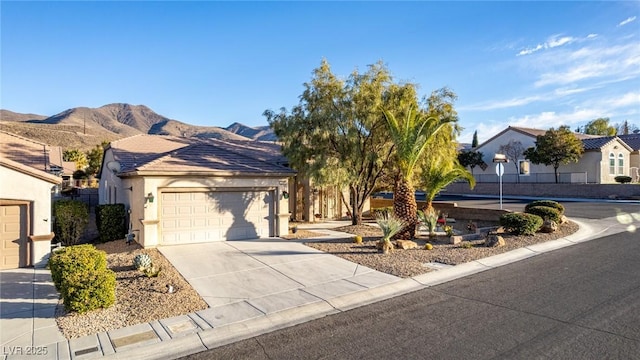 view of front of house with a mountain view and a garage