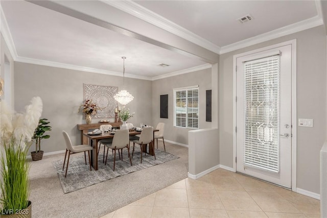 carpeted dining space with a notable chandelier and ornamental molding