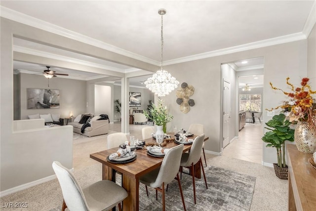 carpeted dining area with ornamental molding and ceiling fan with notable chandelier