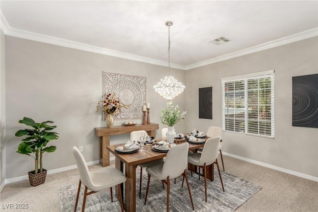 dining area featuring ornamental molding, carpet floors, and a notable chandelier