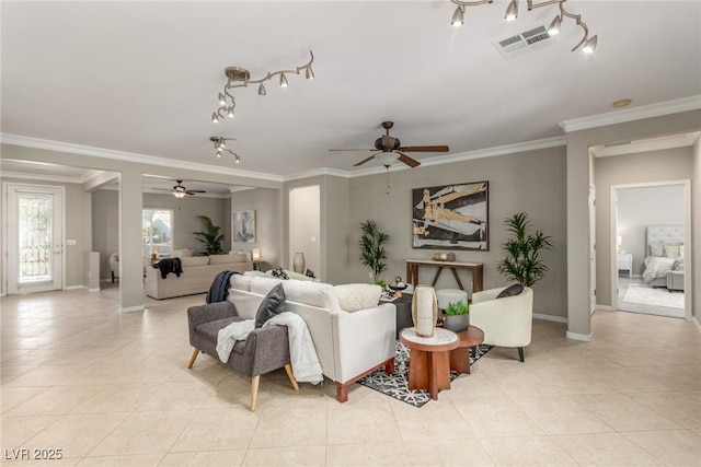 tiled living room with ceiling fan and crown molding