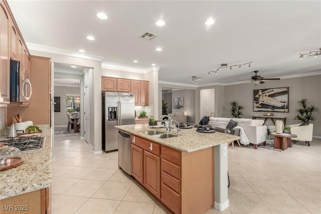 kitchen featuring light stone countertops, sink, stainless steel appliances, and light tile patterned flooring