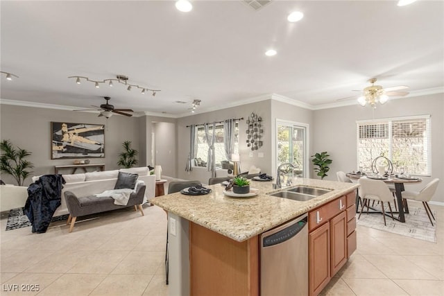 kitchen with an island with sink, light tile patterned flooring, dishwasher, ornamental molding, and sink