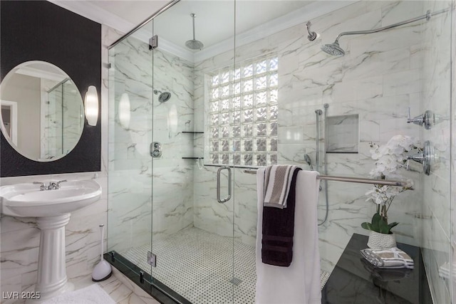 bathroom with a shower with shower door, sink, and crown molding