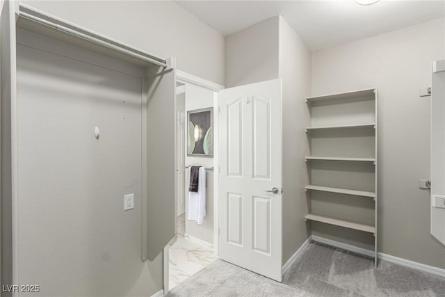 walk in closet featuring light carpet