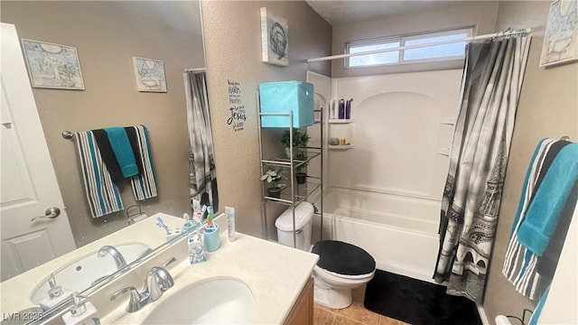 full bathroom featuring toilet, vanity, tile patterned flooring, and shower / bath combo