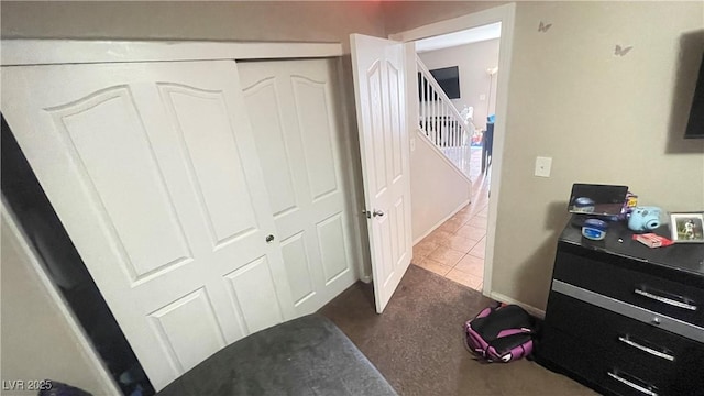 bedroom featuring a closet and dark tile patterned flooring