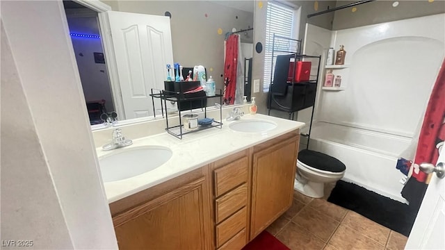 full bathroom featuring toilet, vanity, tile patterned floors, and shower / bathtub combination with curtain