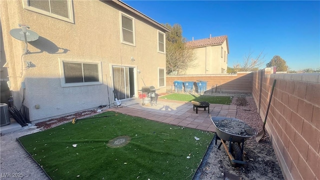 back of property featuring an outdoor fire pit, a lawn, and a patio