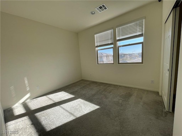 empty room with dark colored carpet