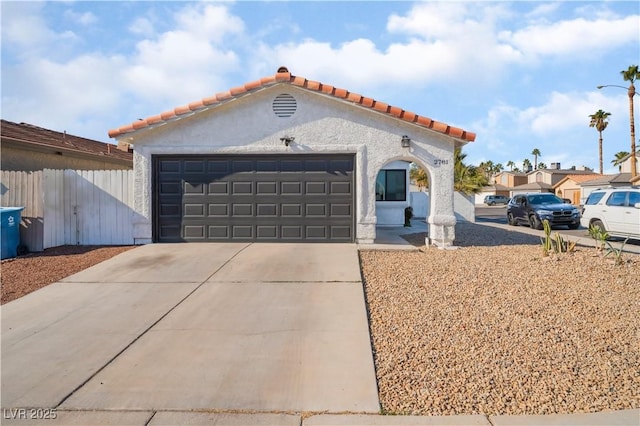 mediterranean / spanish-style house with a garage