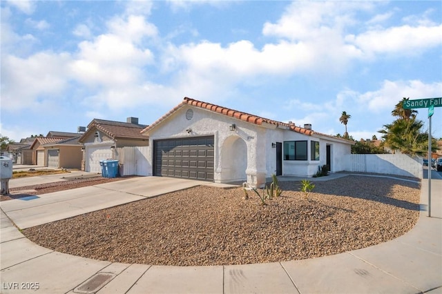 mediterranean / spanish-style home featuring a garage