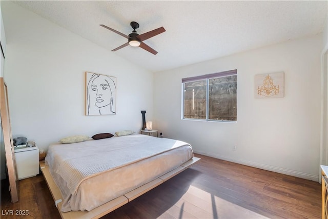 bedroom with ceiling fan, dark hardwood / wood-style floors, and lofted ceiling