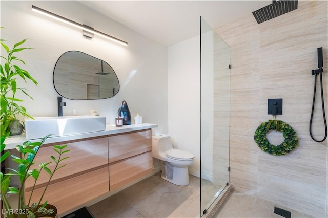 bathroom with walk in shower, vanity, and toilet