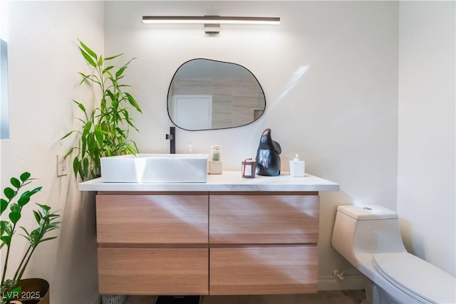 bathroom featuring toilet and vanity