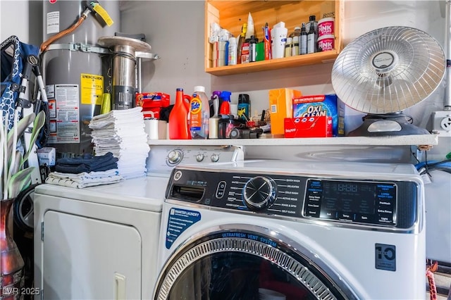 clothes washing area featuring washer and clothes dryer and water heater