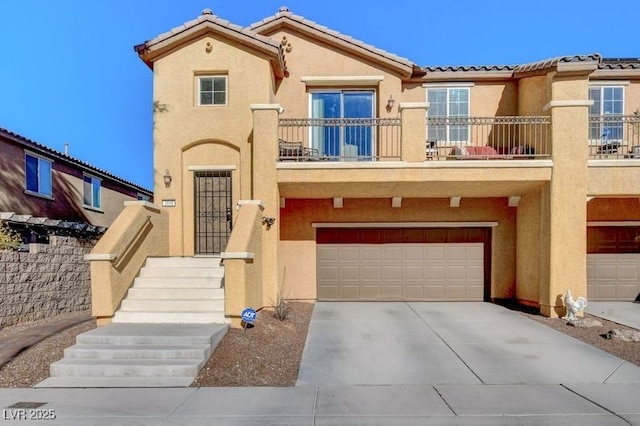 view of front of home featuring a garage and a balcony