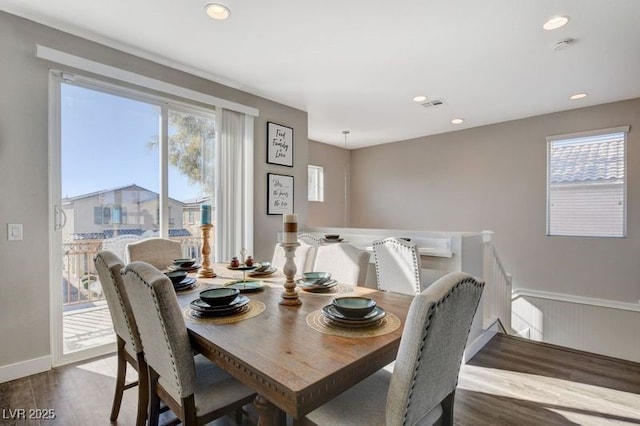 dining room with dark hardwood / wood-style flooring and plenty of natural light