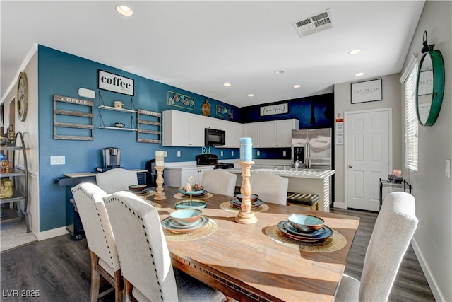 dining area with sink and dark hardwood / wood-style floors