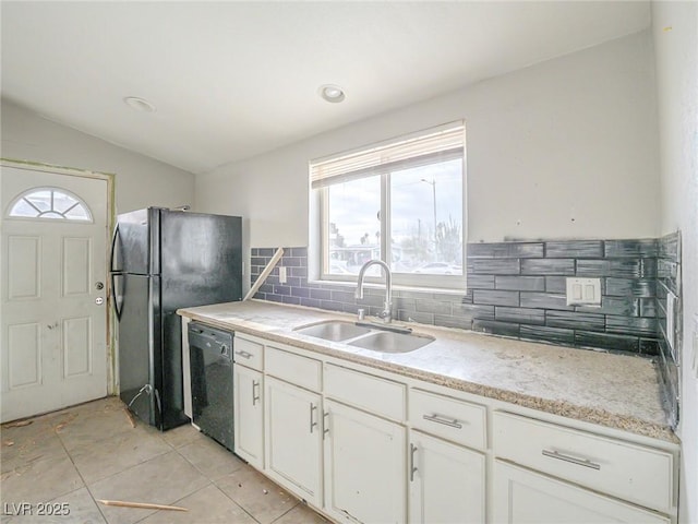 kitchen with sink, white cabinets, black appliances, and lofted ceiling