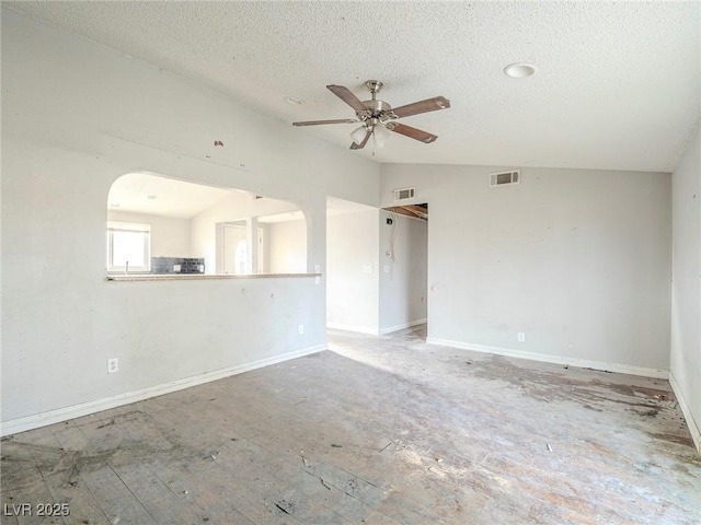 unfurnished room with a textured ceiling, ceiling fan, and vaulted ceiling