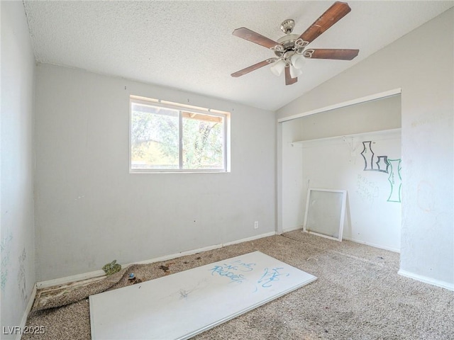 interior space with vaulted ceiling, ceiling fan, and carpet flooring