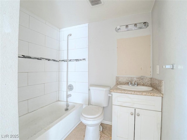 full bathroom featuring toilet, vanity, tiled shower / bath, and tile patterned flooring