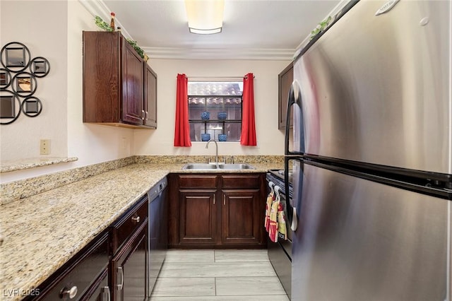 kitchen with dishwasher, sink, stainless steel refrigerator, crown molding, and light stone countertops