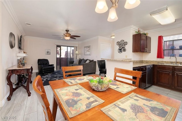 dining space with light wood-type flooring, ceiling fan, ornamental molding, and sink