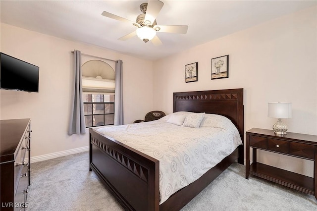 bedroom with ceiling fan and light carpet