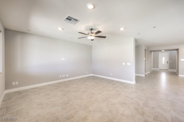 spare room featuring ceiling fan and light tile patterned flooring